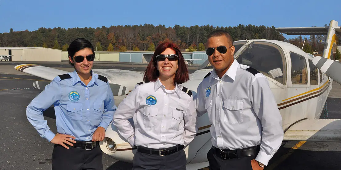 Aviation students in front of airplane