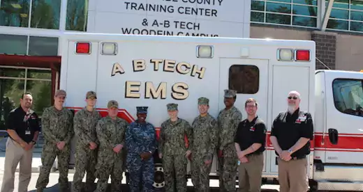 10 men and women standing in front of A-B Tech ambulance