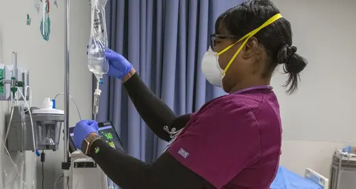 Nursing student checking IV bags