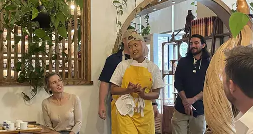 Woman in yellow apron in restaurant