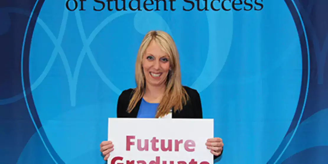 Bridget Cain holding sign that says Future Graduate