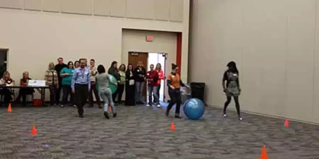 Participants racing with large exercise balls. 
