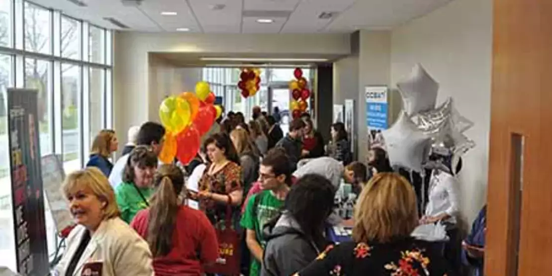 People in Hallway with Career Booths at Find Your Future Open House