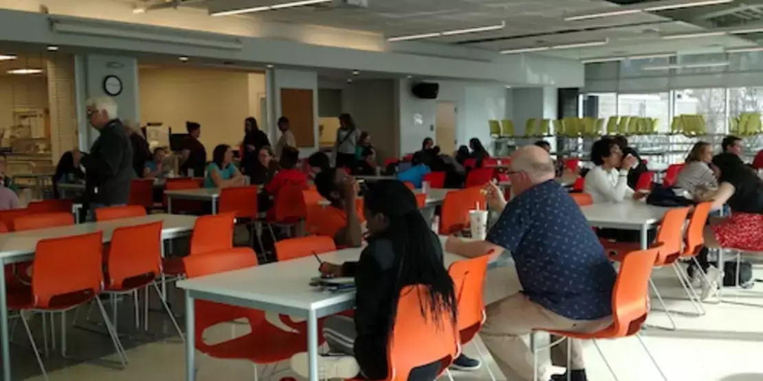 Students and parents in a cafeteria at Asheville Middle School