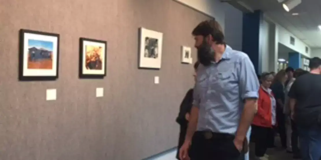 Man and woman looking at artwork on a wall