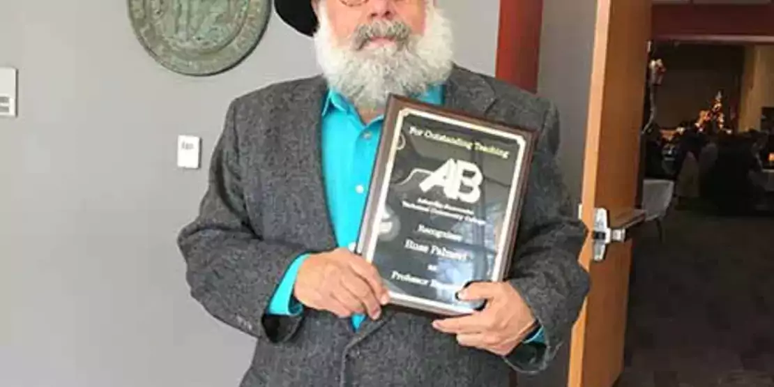 Russ Palmeri holding award