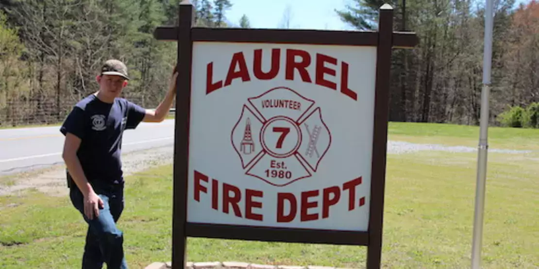 Scott Hensley standing next to the Laurel Fire Dept. sign.